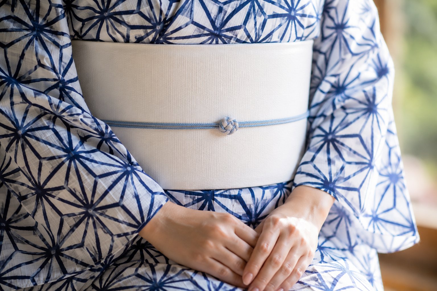 Folded fabrics showing the asanoha hemp leaf pattern in indigo, crimson, pastel and monochrome colorways
